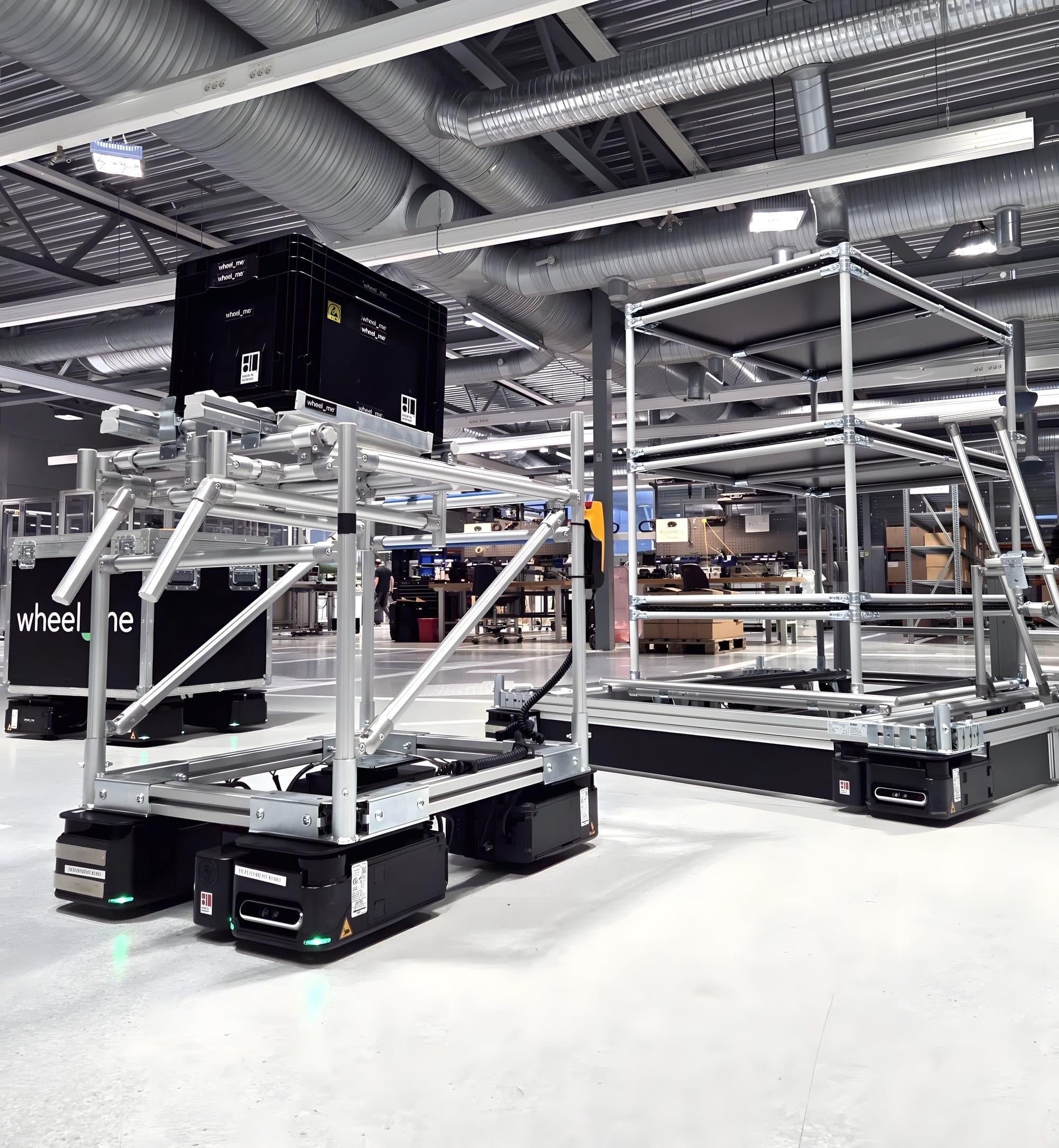 A wheel.me autonomous robot moving an industrial cart
